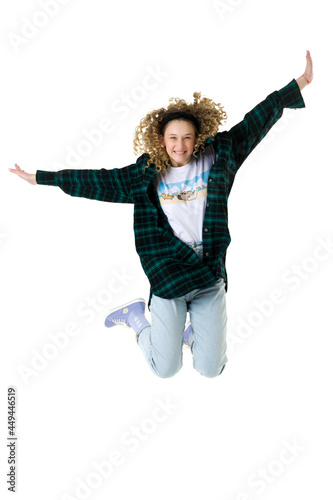 Smiling stylish teen girl having fun jumping high