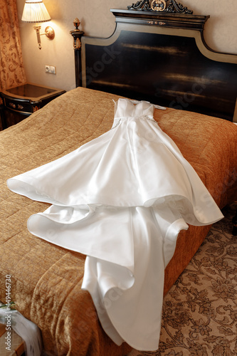 wedding white puffy dress on the bed waiting for the bride