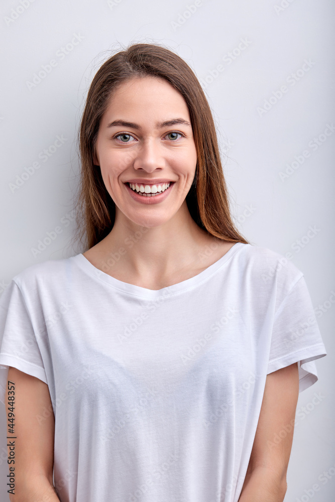 Good-looking Female In Casual Outfit Looking At camera smiling cutely, isolated on white studio background, portrait of attractive lady with natural beauty, no make-up, posing alone. people concept Good-looking Female In Casual Outfit Looking At camera smiling cutely, isolated on white studio background, portrait of attractive lady with natural beauty, no make-up, posing alone. people concept