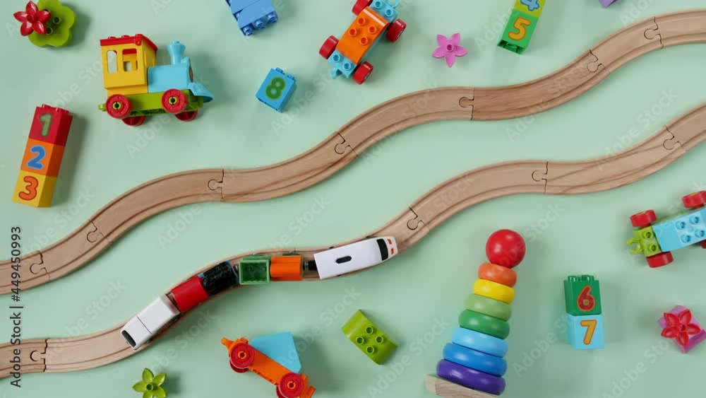 Childish Toy Wooden Railway. Toy Train Travel Along the Railway. Child's Educational Toys. Top View. Copy Space. High quality 4k footage