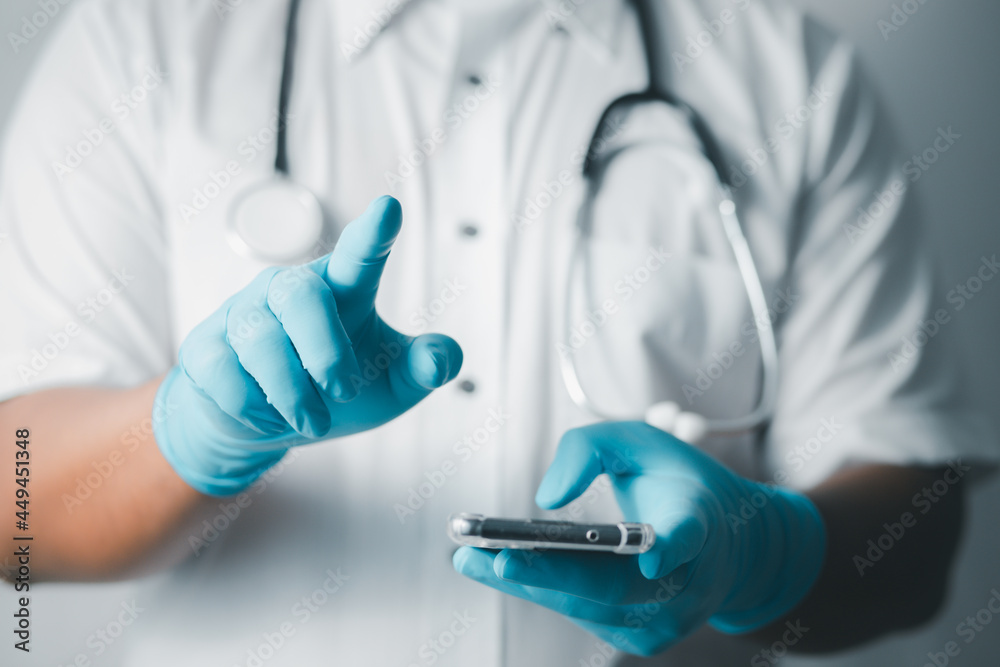 doctor or scientist uses a smartphone to study information about the mutant virus in the lab. Research concepts for COVID-19 virus disease
