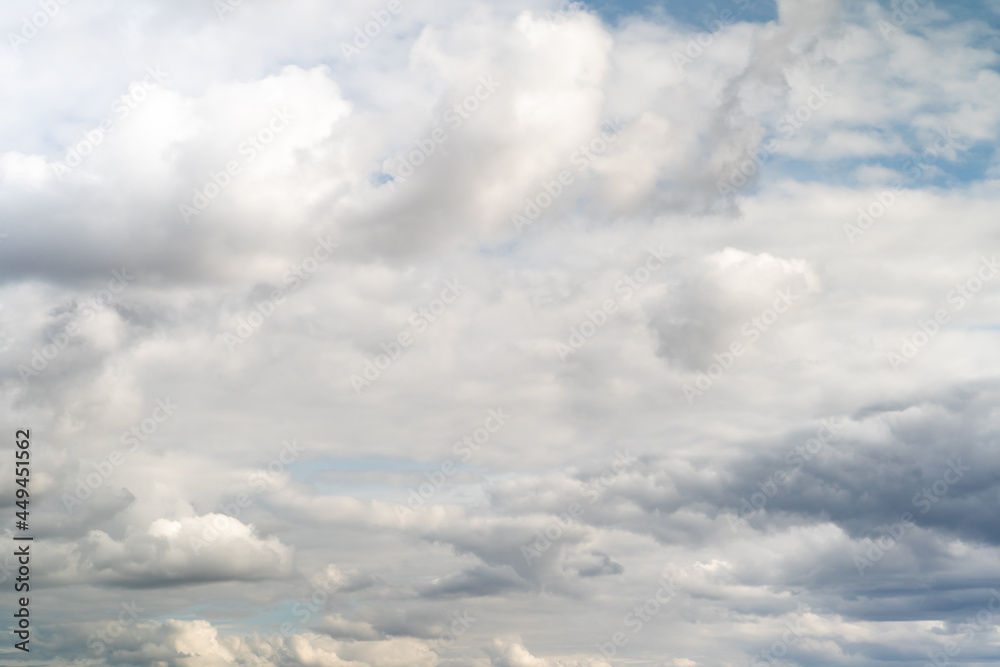 Beautiful fluffy clouds in the evening sky. The sunlight gives a side light on the clouds. Clouds before rain. Beautiful fluffy clouds in the evening sky. The sunlight gives a side light on the clouds. Clouds before rain.