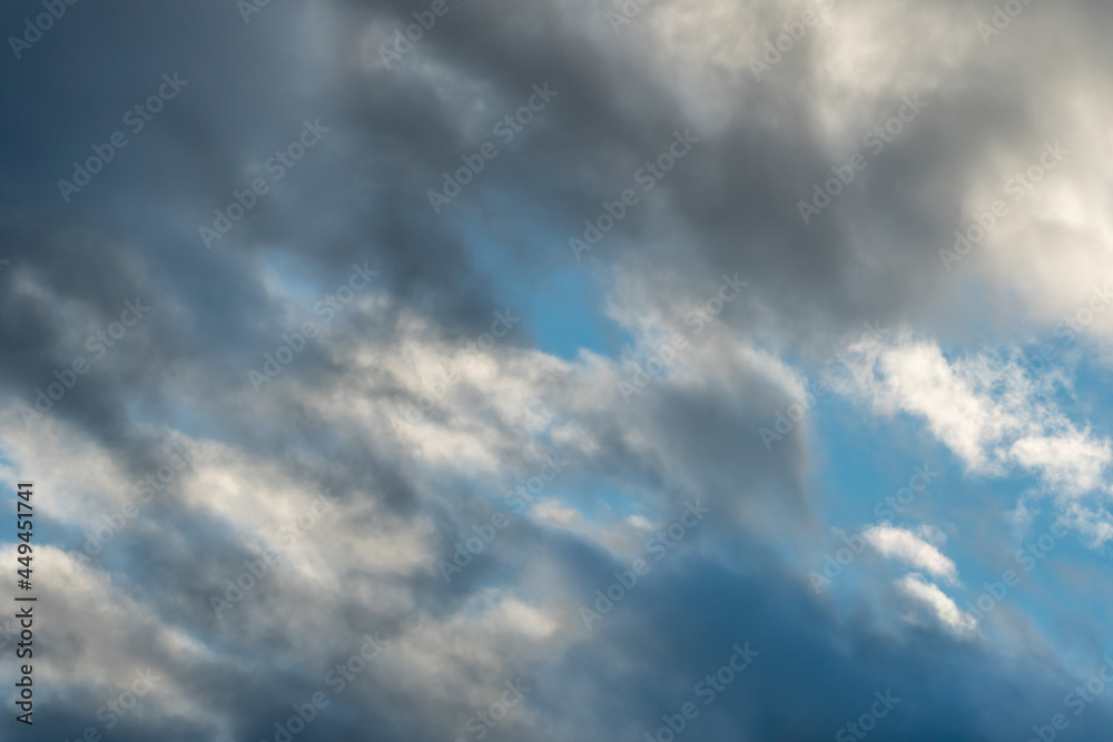 Beautiful fluffy clouds in the evening sky. The sunlight gives a side light on the clouds. Clouds before rain. Beautiful fluffy clouds in the evening sky. The sunlight gives a side light on the clouds. Clouds before rain.