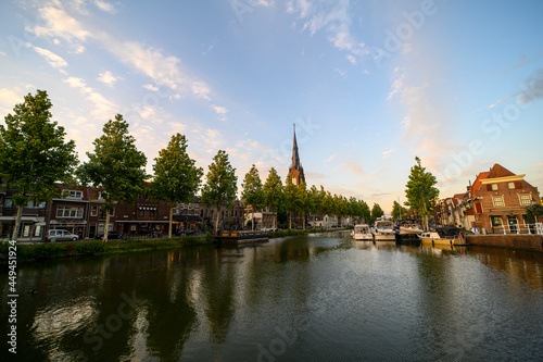 A canal flowing through the city of Weesp on a summer evening