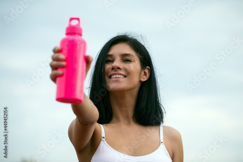 Sport and lifestyle concept. Sport bottle. Female. Fit body woman. Fitness. 