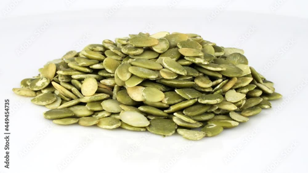 Pile of yellow-green sunflower seeds rotating, close-up 360 degrees loop, 30 fps Pile of yellow-green sunflower seeds rotating, close-up 360 degrees loop, 30 fps