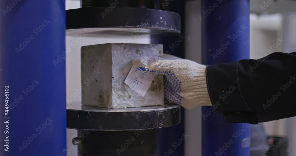 Close-up, a concrete sample is inserted into a pressing machine. Testing the strength of concrete in the laboratory. 4k, ProRes