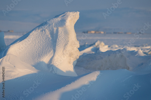 Winter arctic landscape. Ice hummocks on the frozen sea in the Arctic. Cold frosty winter weather. Harsh polar climate. View of snow and ice at sunset. Snow-covered ice hummocks close-up. Far North. © Andrei Stepanov