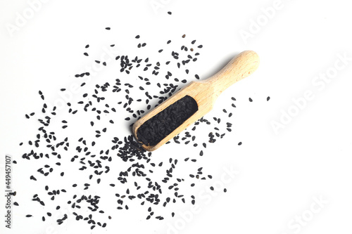 Nigella sativa or Black cumin in wooden spoon isolated on white background photo