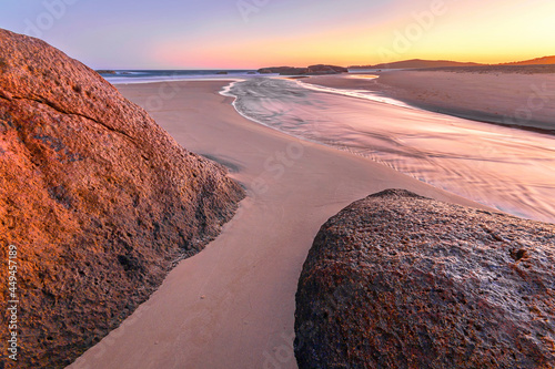 a view of a rocky beach at dawn