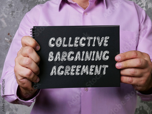Business concept about COLLECTIVE BARGAINING AGREEMENT with phrase on the sheet. photo