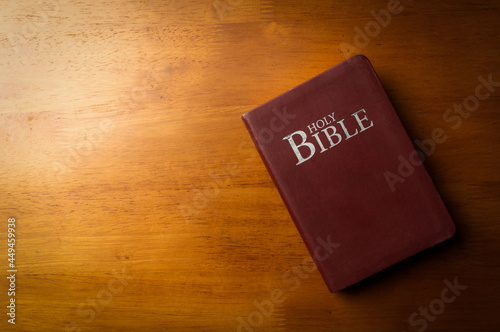 Holy bible with note book and pencil on wooden table for christian devotion and copy space