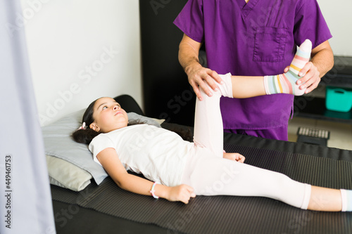 Physical therapist treating a kid patient
