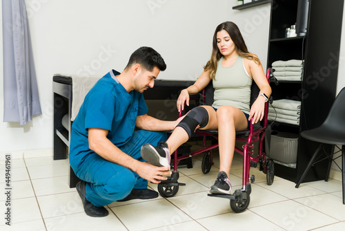 Young woman with a knee injury at the clinic photo