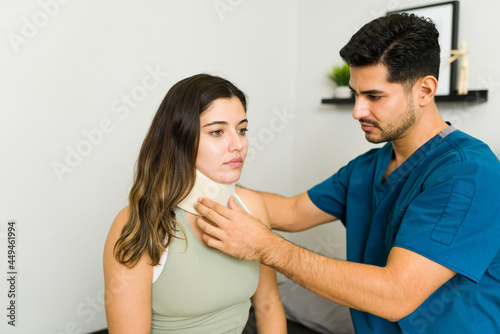 Therapist putting an orthopedic collar on a patient