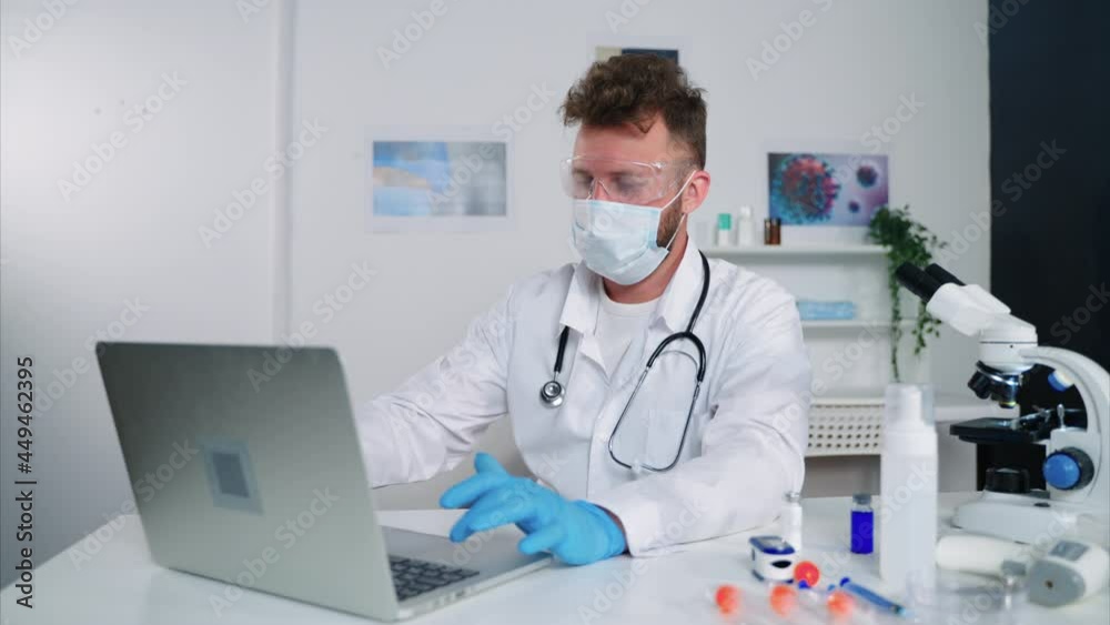 male employee of medical research laboratory is working in office, filling test result in database male employee of medical research laboratory is working in office, filling test result in database