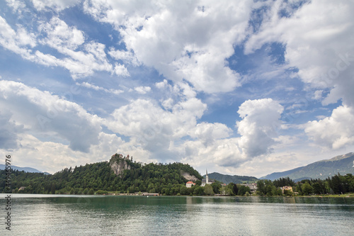 Panorama of the Bled lake, Blejsko Jezero, with its castle, Blejski Hrad and the Saint Martin church, or Cerkev Svetog Martina during a sunny afternoon. Bled Castle is a major monument of Slovenia...