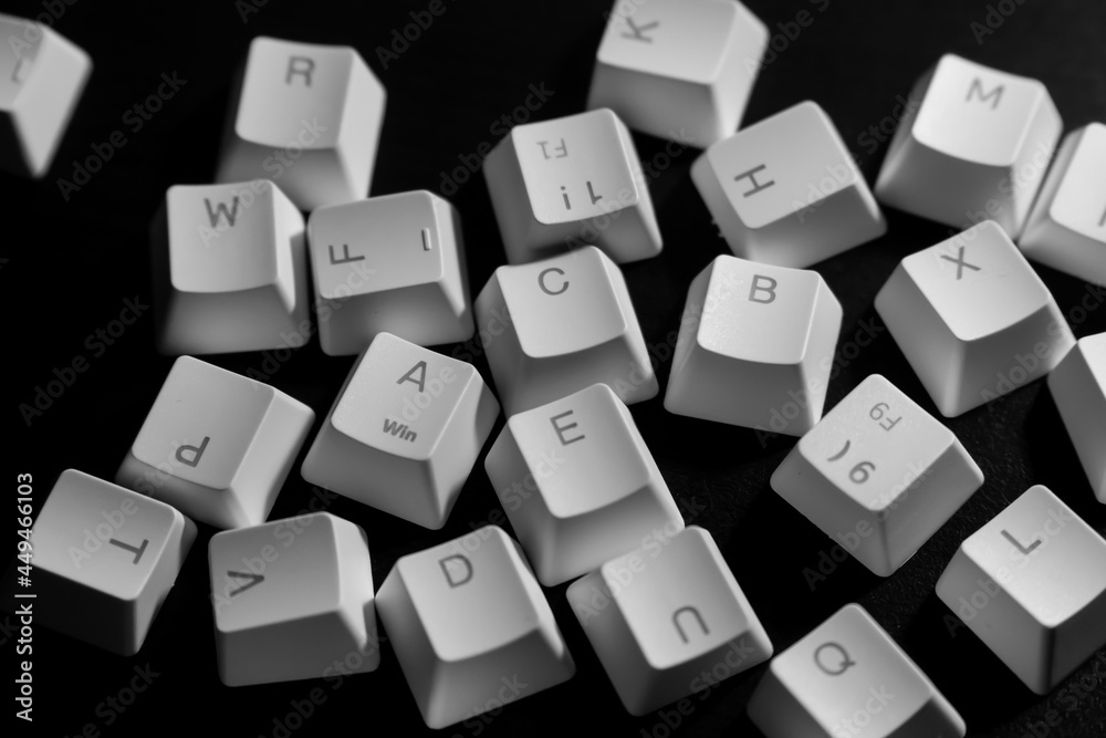 Random letters of keycaps or keyboard buttons on black background. Random Alphabet. Random letters of keycaps or keyboard buttons on black background. Random Alphabet.