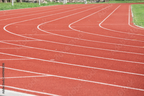 Selective blur on the curve on a running track, an athletics field used for athletism competition, like sprint, or running race, and for olympic competitive events. .. photo