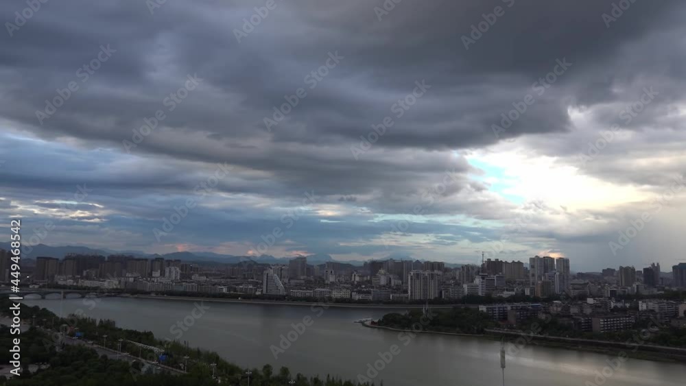 Time-lapse of the changing dark clouds over a city in the evening Time-lapse of the changing dark clouds over a city in the evening