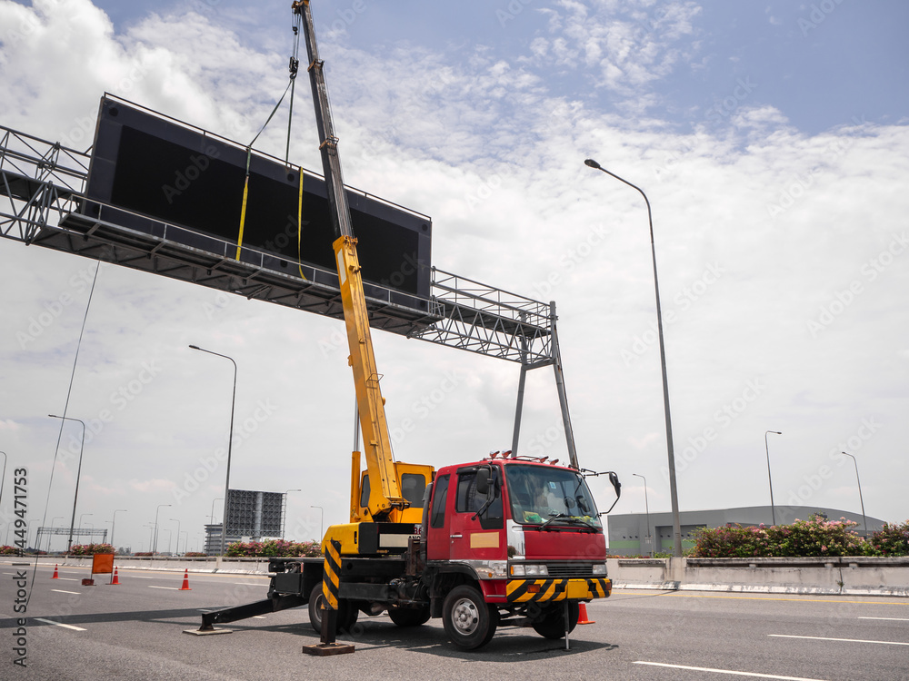 Construction site crane is lifting a led signboard for advertisement Construction site crane is lifting a led signboard for advertisement