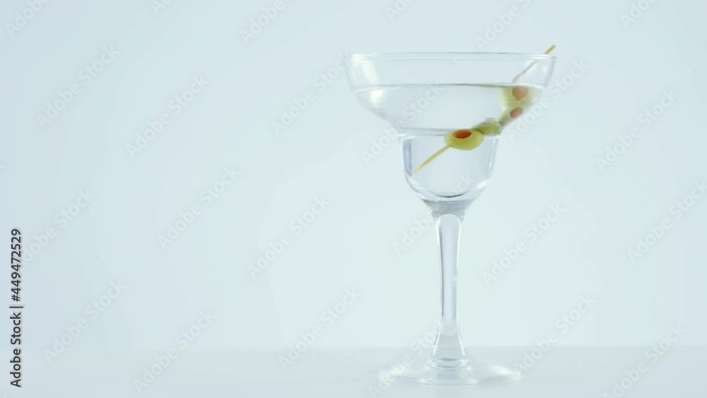 Chevron pattern design over olives in cocktail glass against grey background Chevron pattern design over olives in cocktail glass against grey background
