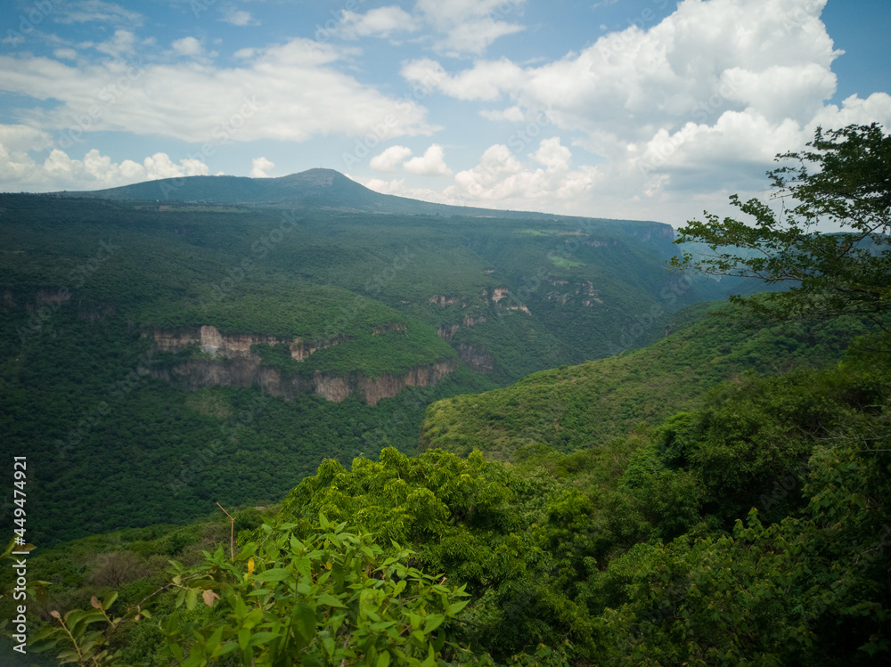 Green canyon with cloudy sky