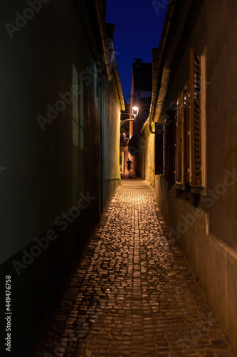 Dark narrow street alley human silhouette walking