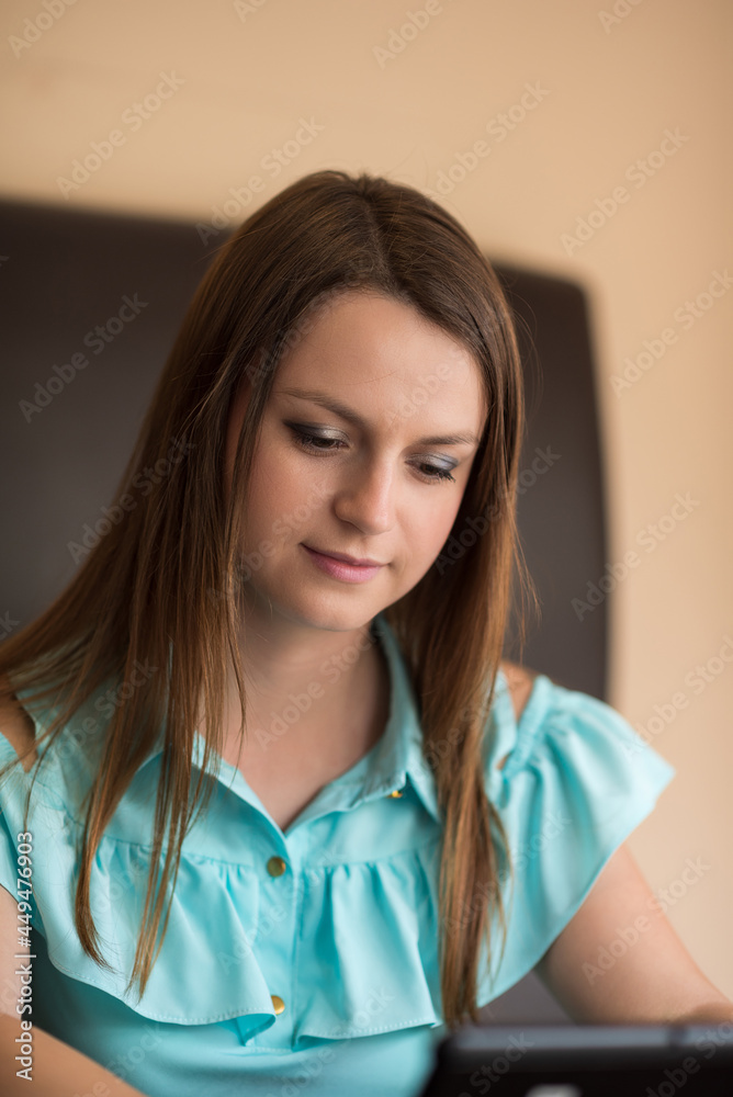 Portrait of a young beautiful brown-haired woman with long hair indoors. Portrait of a young beautiful brown-haired woman with long hair indoors.