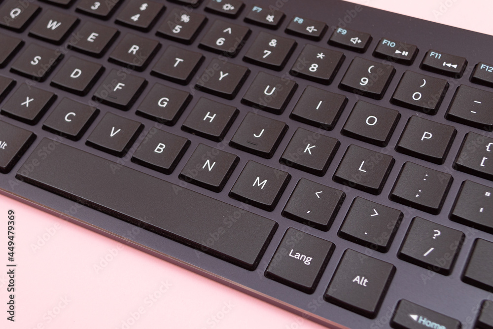 Black Bluetooth Keyboard for Tablet or PC on Pink Background Black Bluetooth Keyboard for Tablet or PC on Pink Background