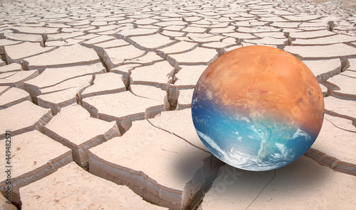 Global warming concept - Planet Earth on dry soil with planet of Mars "Elements of this image furnished by NASA "