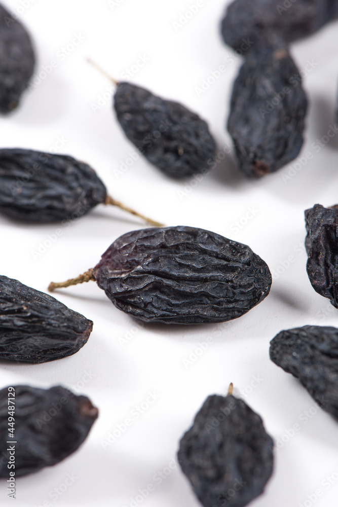 Dried black raisins isolated on white background Dried black raisins isolated on white background