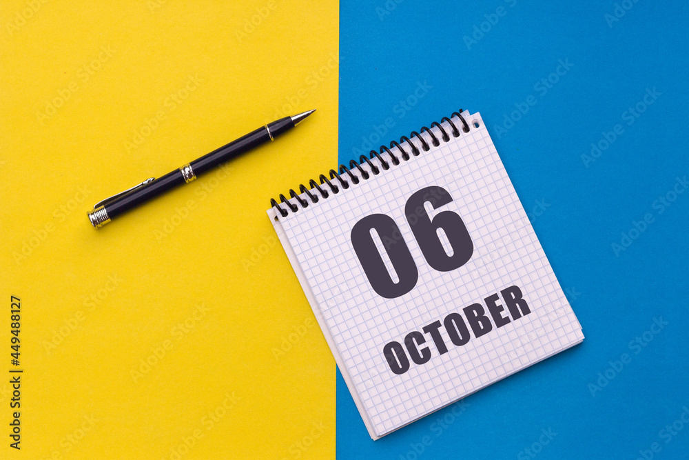 October 6th. Day 6 of month, calendar date. Notebook with a spiral and pen lies on a yellow-blue background October 6th. Day 6 of month, calendar date. Notebook with a spiral and pen lies on a yellow-blue background