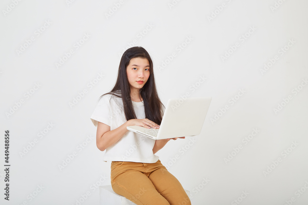 woman with laptop computer sitting cross legged and looking woman with laptop computer sitting cross legged and looking