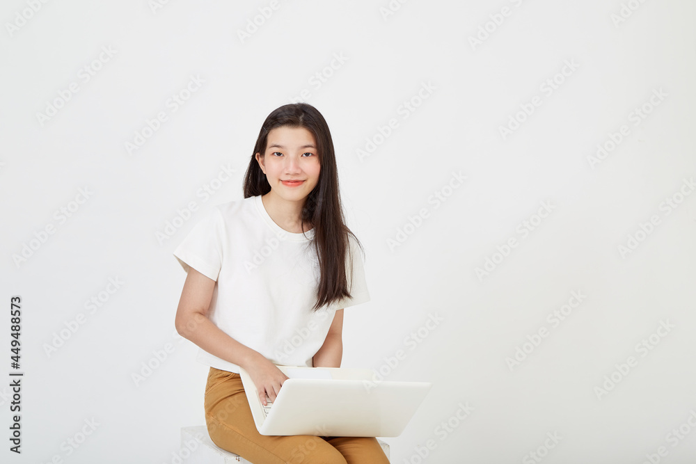 woman with laptop computer sitting cross legged and looking woman with laptop computer sitting cross legged and looking