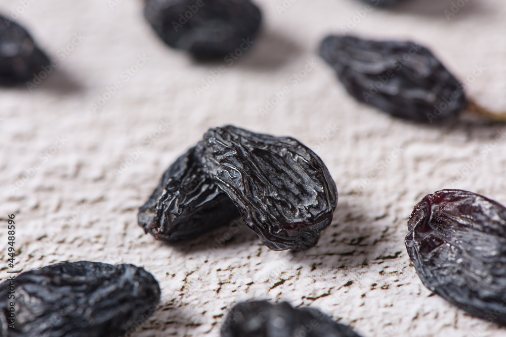 Dried fruits, pile of black raisins on table. Dried fruits, pile of black raisins on table.