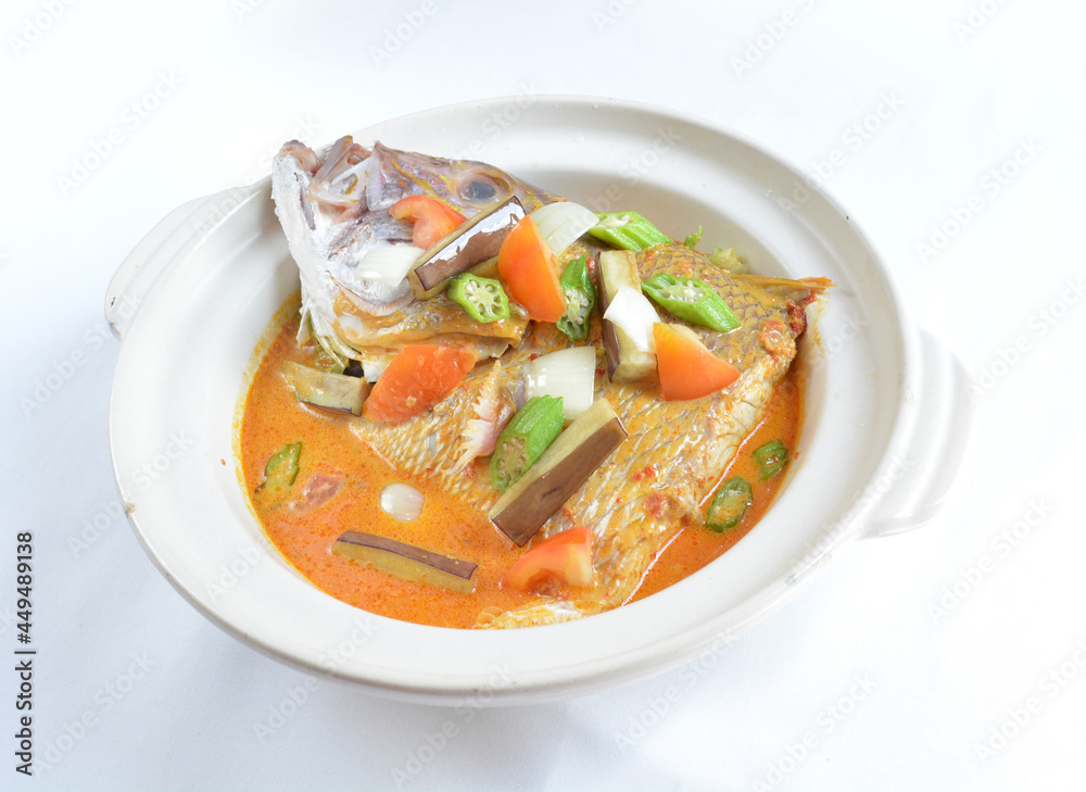 local spicy chilli curry soup big grouper fish head with vegetables in hot clay pot in white background asian halal seafood menu local spicy chilli curry soup big grouper fish head with vegetables in hot clay pot in white background asian halal seafood menu