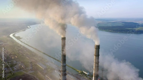 Aerial view of coal power plant high pipes with black smokestack polluting atmosphere. Electricity production with fossil fuel concept photo