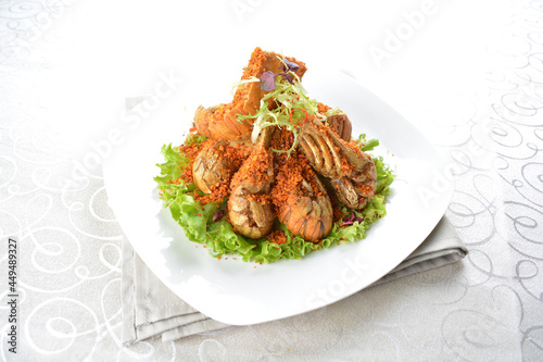 stir fried crayfish prawn seafood with butter spicy cereal milk sauce taste in white background asian halal seafood menu