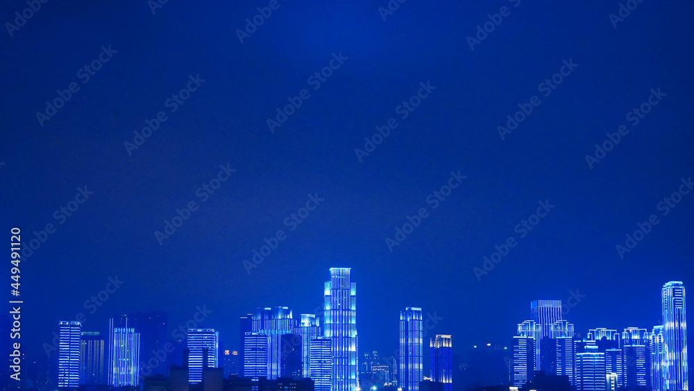 Beautiful night view of a modern city and tall buildings, blue background