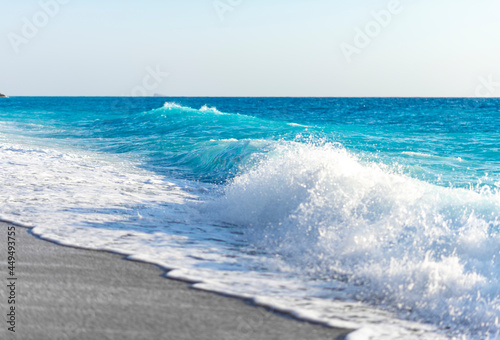 Tropical  sand beach and blue sky, hot summer day, waves on the beach