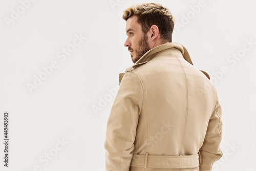 handsome man in coat autumn style fashion back view light background