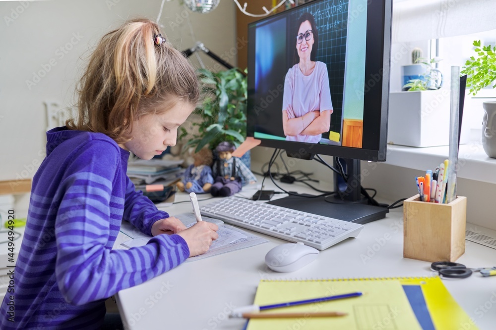 Preteen girl learning math online using home computer Preteen girl learning math online using home computer
