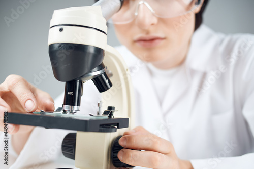 woman laboratory assistant microscope research science