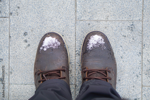 Winter season,snowing outside,The shot of two pairs of winter shoes covered with snow is made from the top view,Close up of snowflake structure,A couple in winter boots