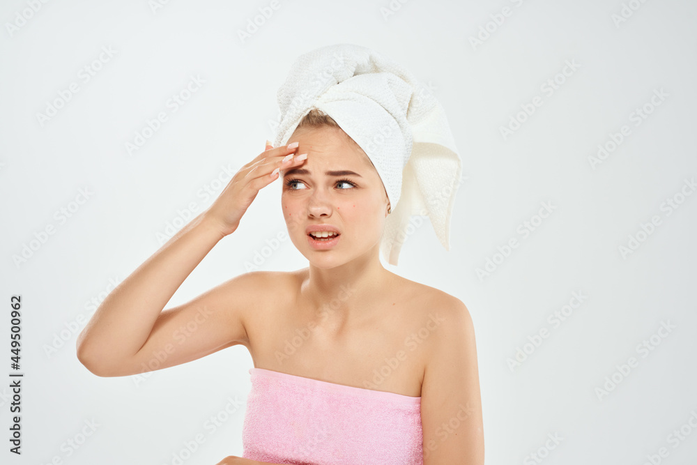 woman with towel on head holding face skin care dermatology health woman with towel on head holding face skin care dermatology health