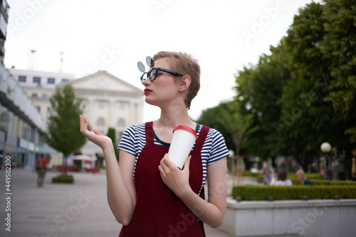 woman with short hair on the street wearing sunglasses 