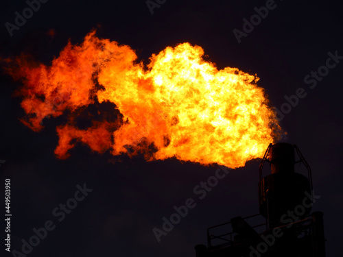 Blaze fire flame texture background. Fire flames collection isolated on black background. Gas flare is releasing and burning to the atmosphere at an offshore gas platform with night sky.