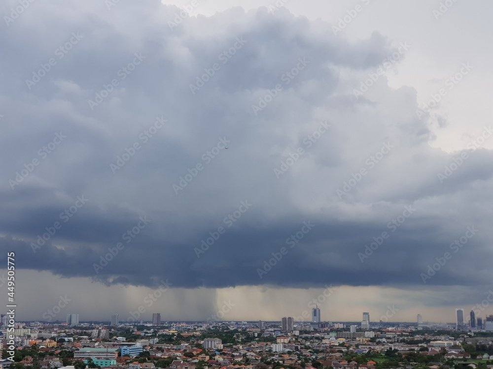 Rain clouds are falling far in the city.