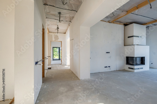 Empty unfurnished corridor room with minimal preparatory repairs. interior with white walls and drywall